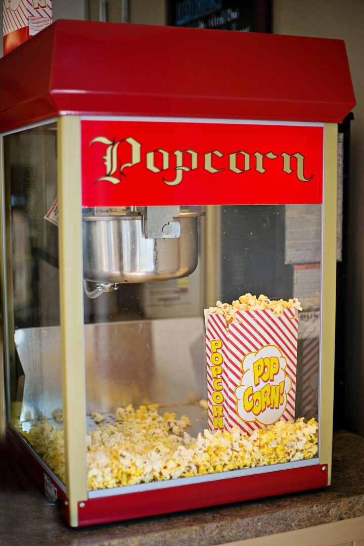 A popcorn machine in red and yellow color.